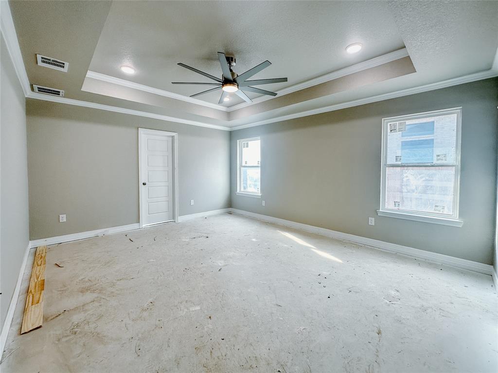 1341 Promised Land Road Hewitt, TX 76643 - Photo 22 of 34 en empty room with windows and ceiling fan