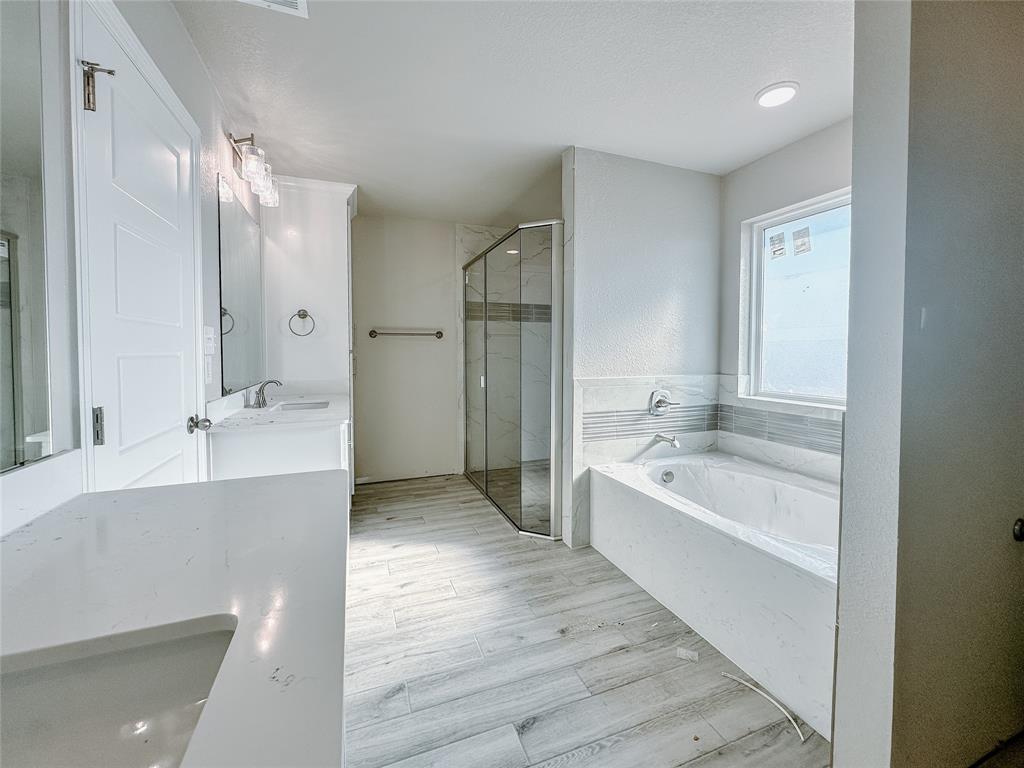 1341 Promised Land Road Hewitt, TX 76643 - Photo 23 of 34 a spacious bathroom with a bathtub shower sink double and mirror