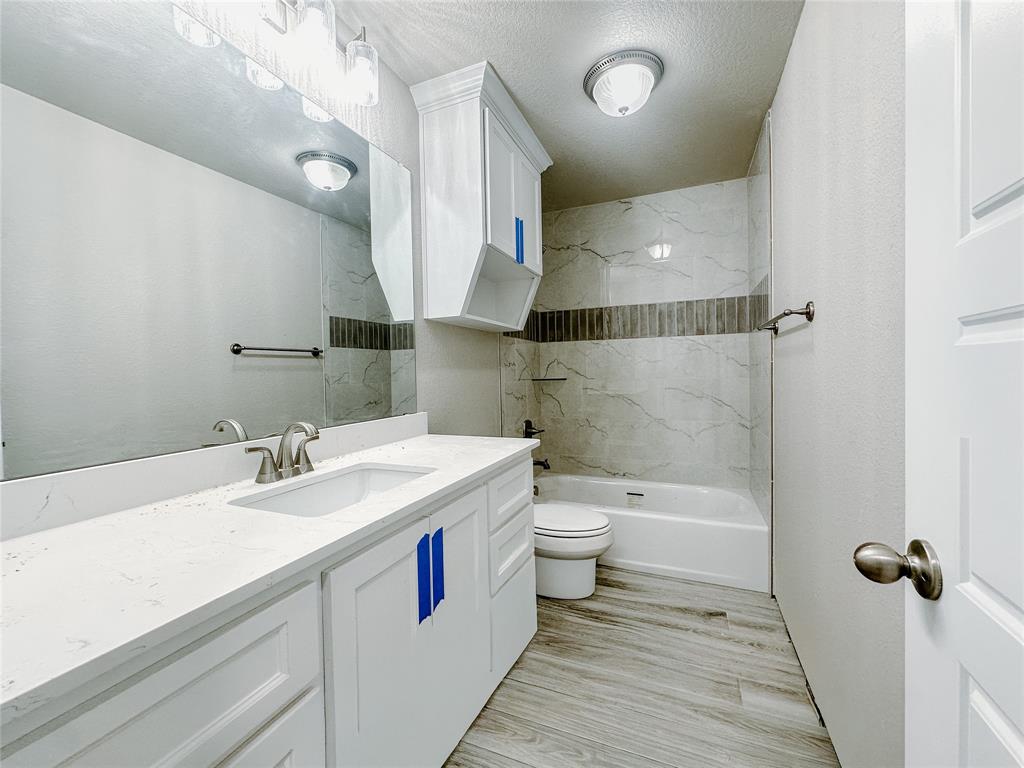 1341 Promised Land Road Hewitt, TX 76643 - Photo 25 of 34 a bathroom with a sink a toilet and a mirror