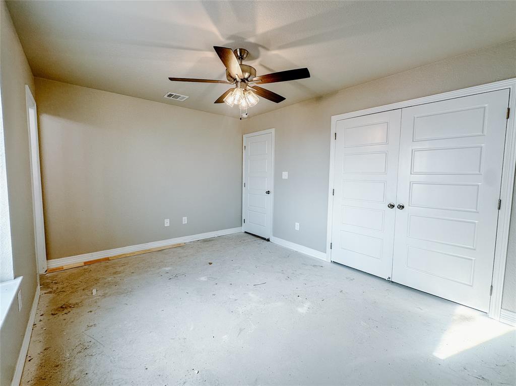 1341 Promised Land Road Hewitt, TX 76643 - Photo 29 of 34 an empty room with closet and a chandelier fan