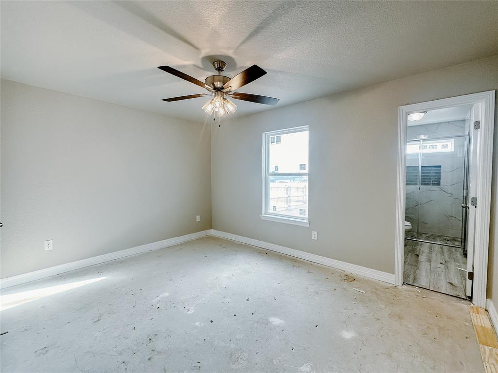 1341 Promised Land Road Hewitt, TX 76643 - Photo 30 of 34 an empty room with chandelier fan and windows