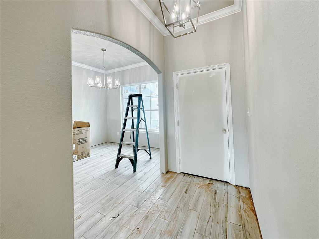 1341 Promised Land Road Hewitt, TX 76643 - Photo 4 of 34 a view of a room with wooden floor staircase and a chandelier