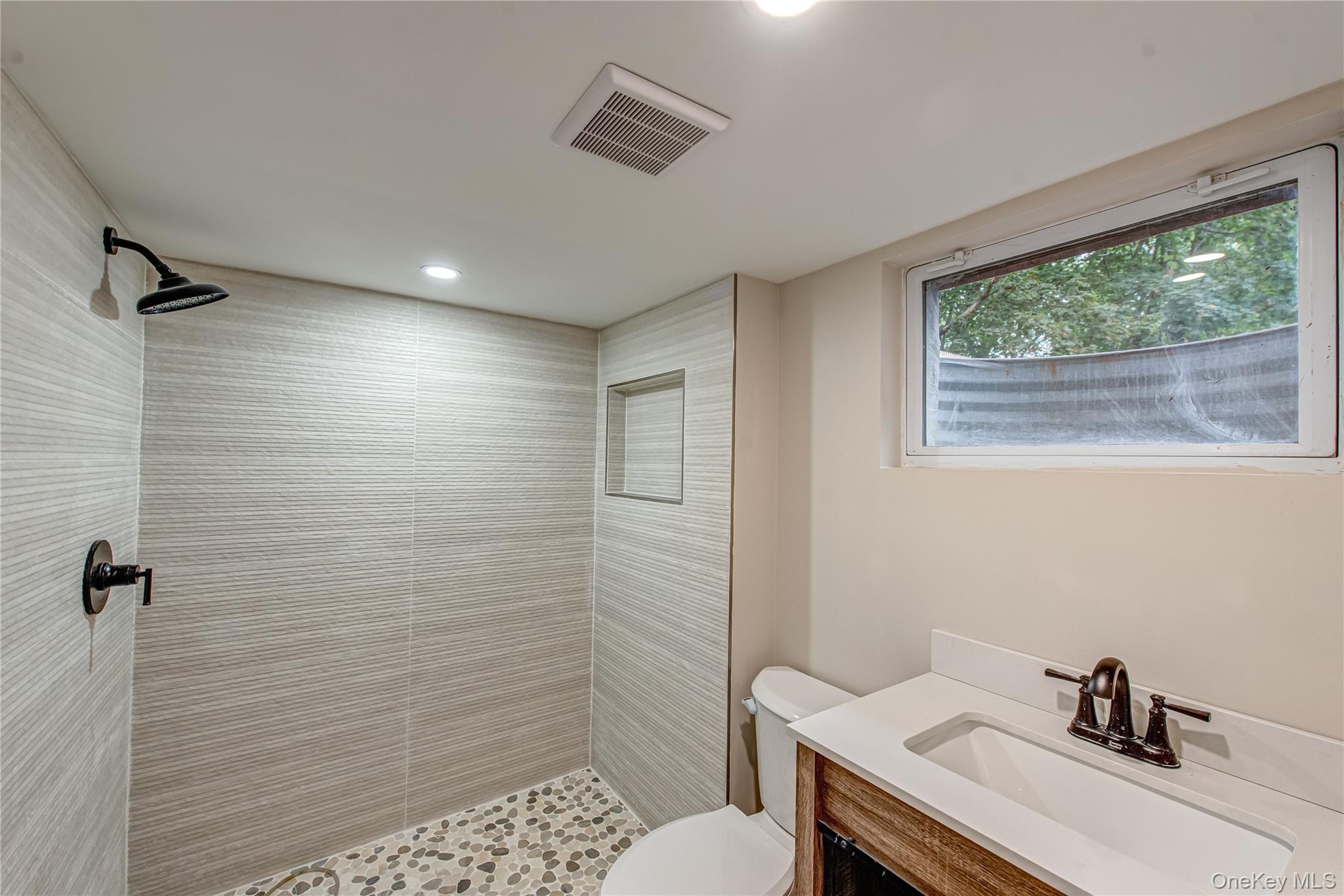 31 Terrell Street Patchogue, NY 11772 - Photo 18 of 21 a bathroom with a sink toilet and shower