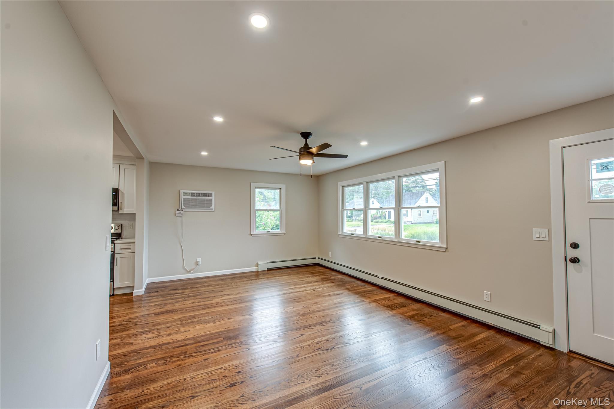31 Terrell Street Patchogue, NY 11772 - Photo 5 of 21 an empty room with wooden floor and windows