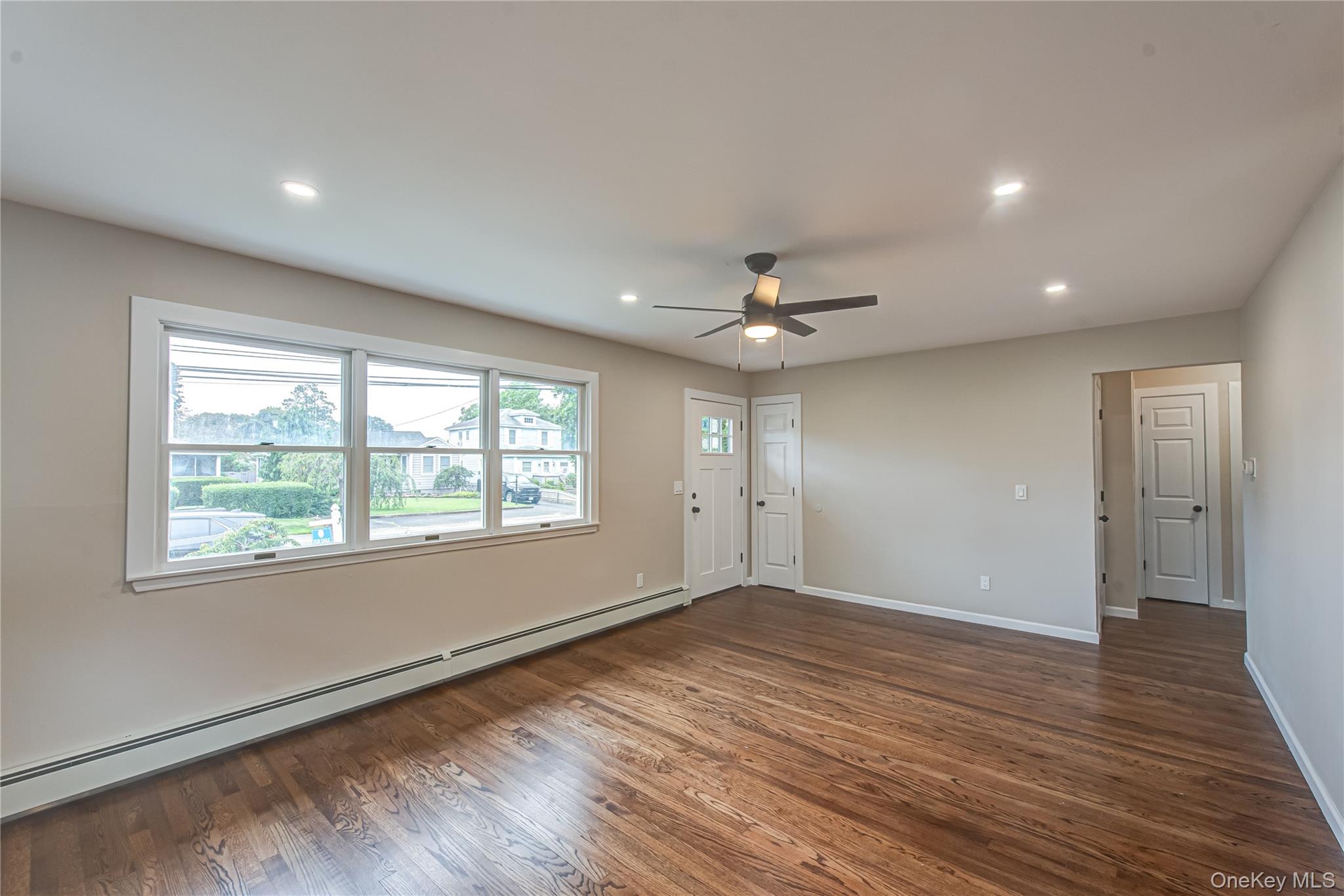 31 Terrell Street Patchogue, NY 11772 - Photo 6 of 21 a view of an empty room with wooden floor and a window