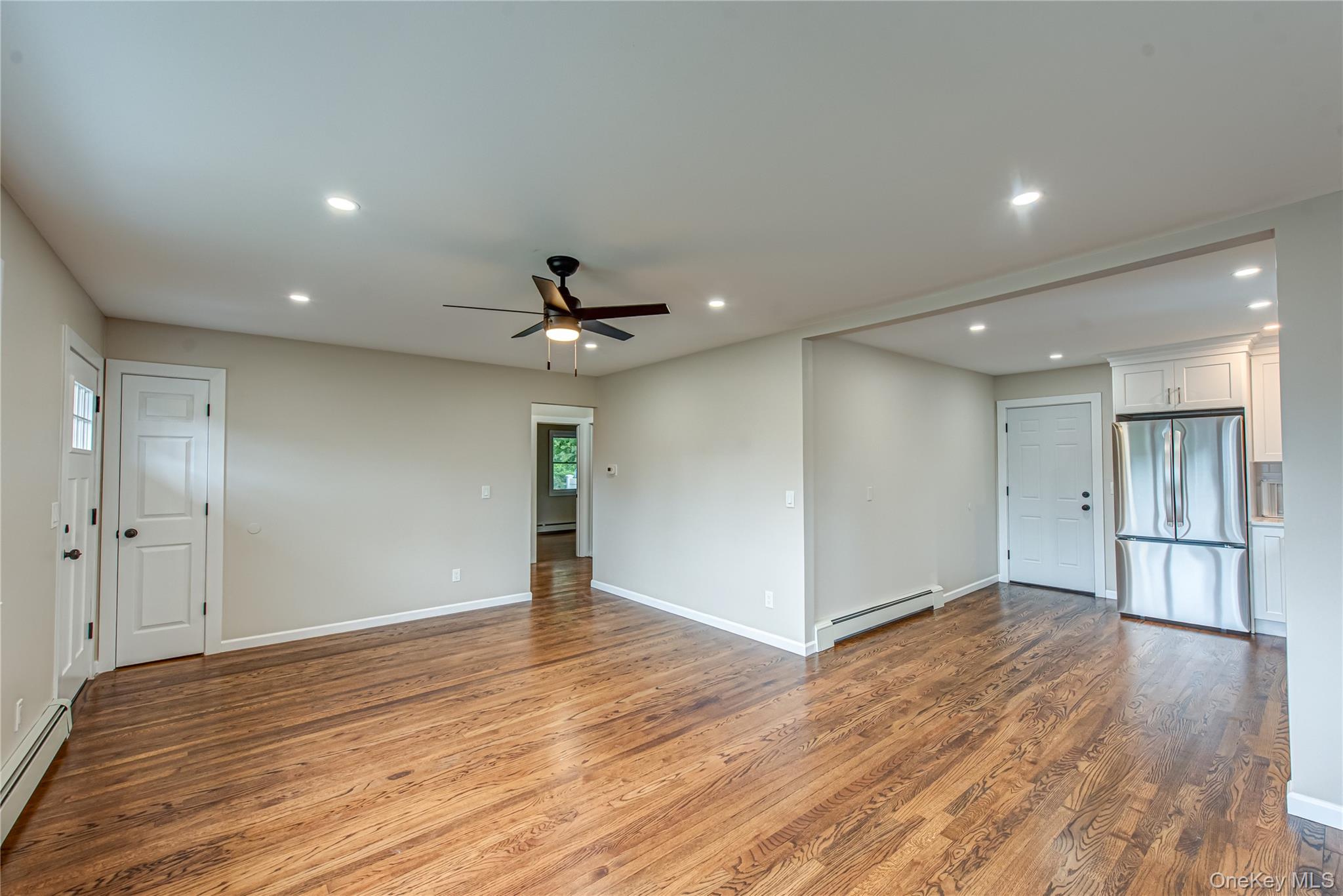 31 Terrell Street Patchogue, NY 11772 - Photo 7 of 21 a view of an empty room with wooden floor and a window