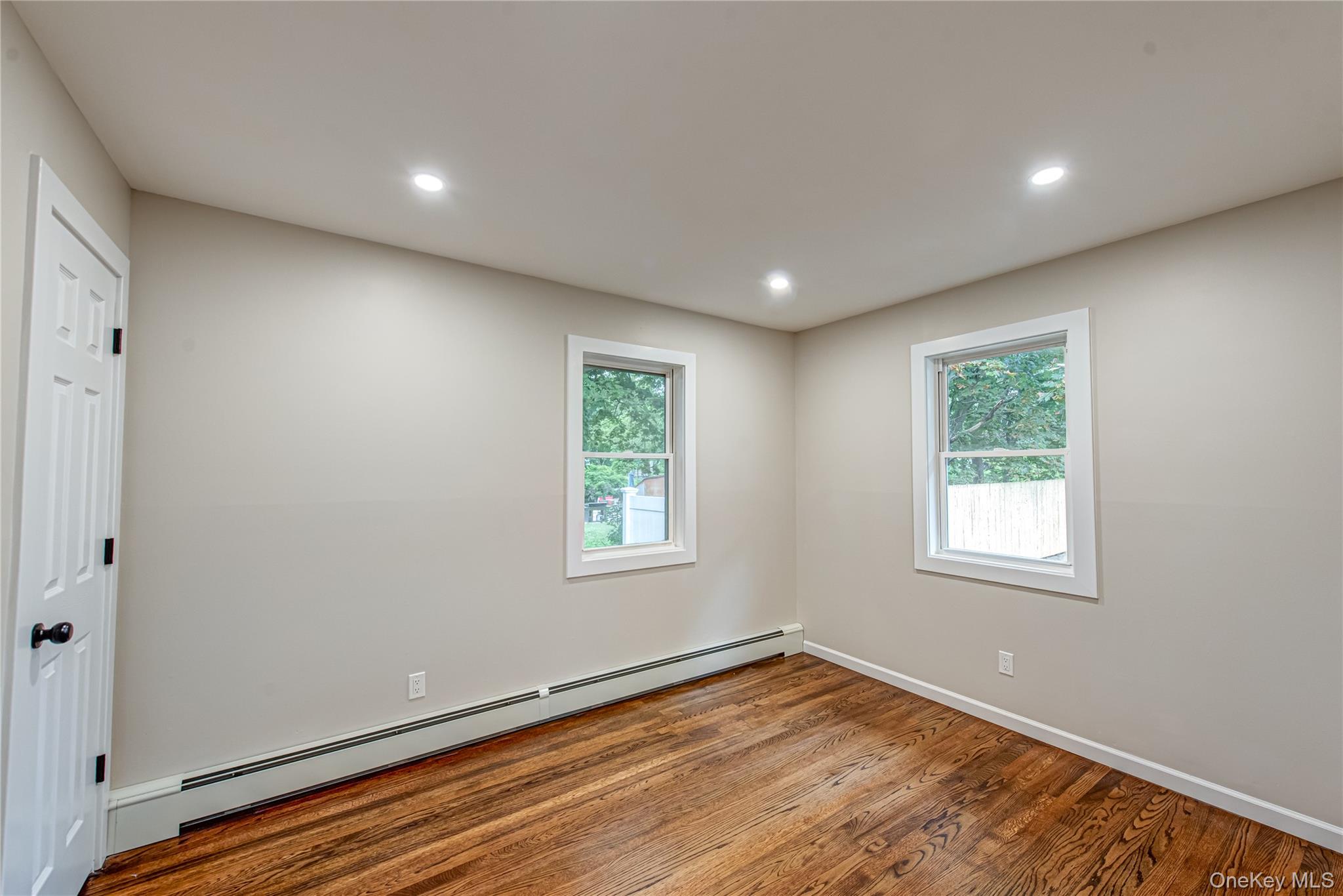 31 Terrell Street Patchogue, NY 11772 - Photo 9 of 21 a view of an empty room with wooden floor and a window