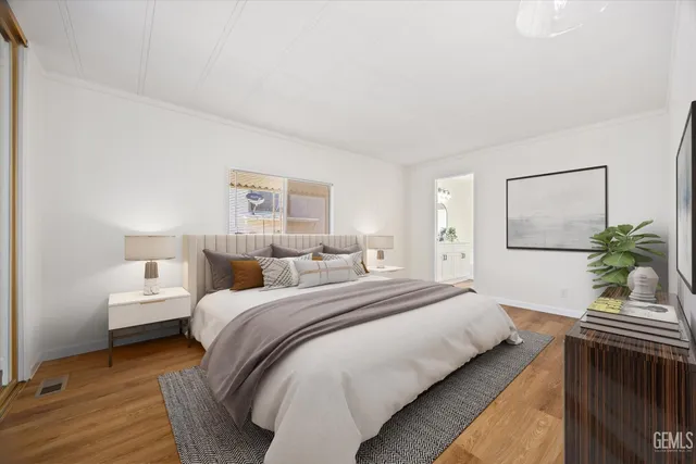 a bedroom with a bed and a potted plant