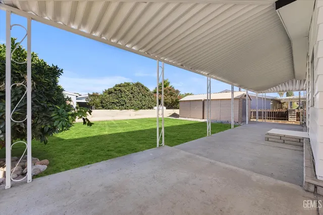 a view of a house with a yard and a street
