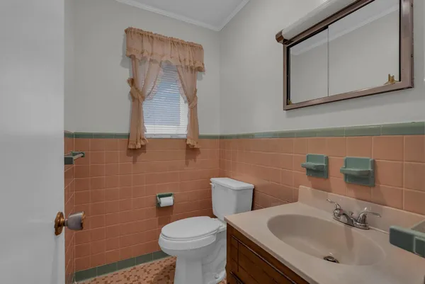 a bathroom with a sink toilet and mirror