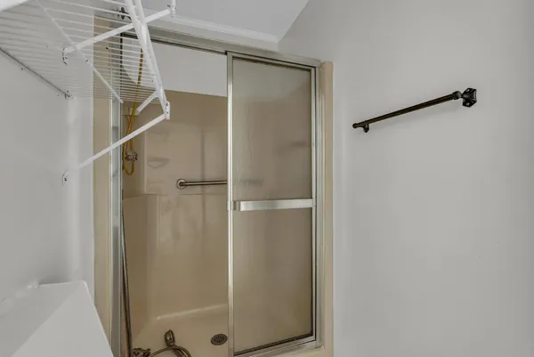 a bathroom with a glass shower door