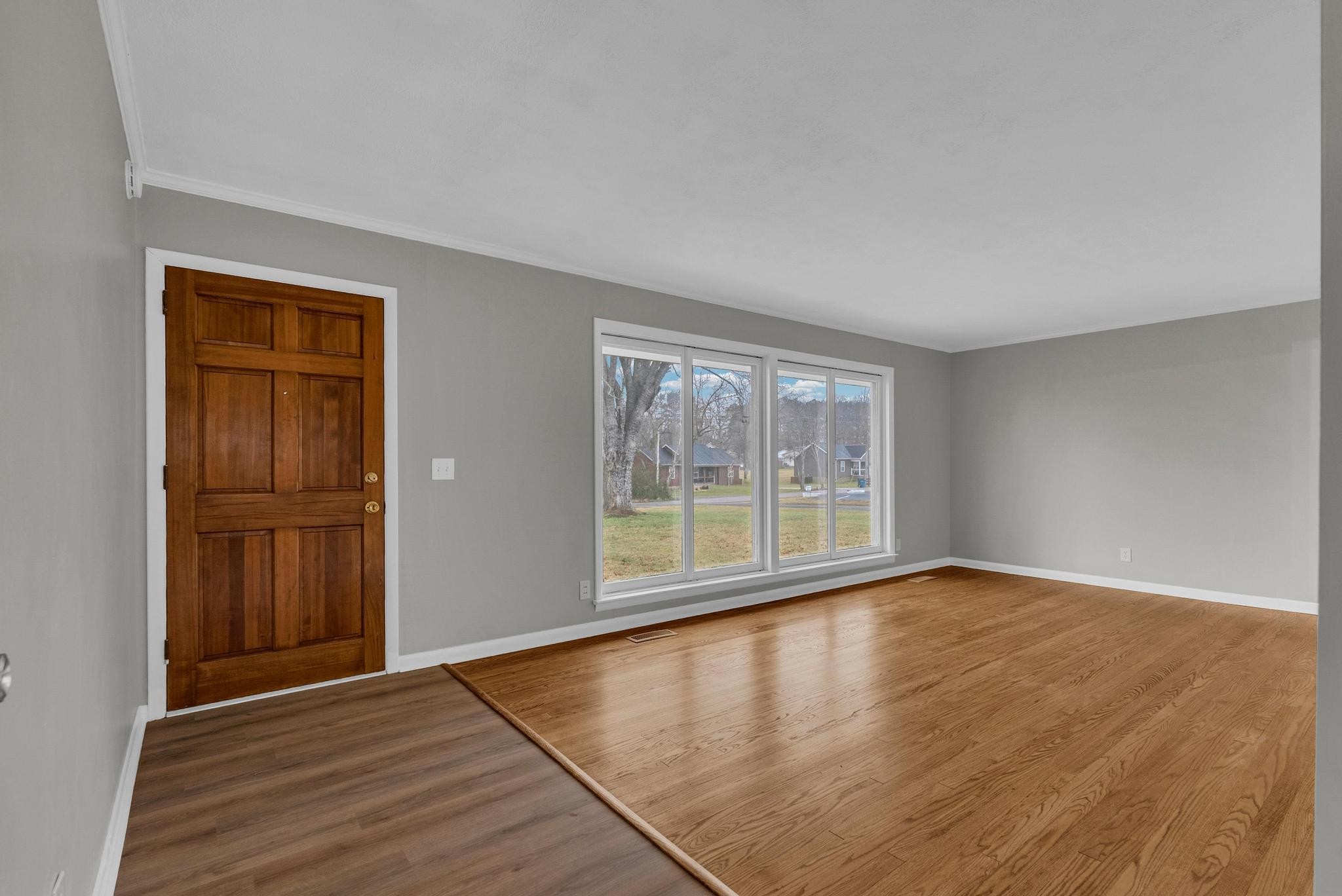 540 4th Avenue South Baxter, TN 38544 - Photo 5 of 26 an empty room with wooden floor and windows