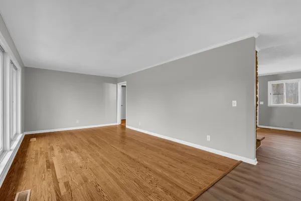 a view of an empty room and wooden floor
