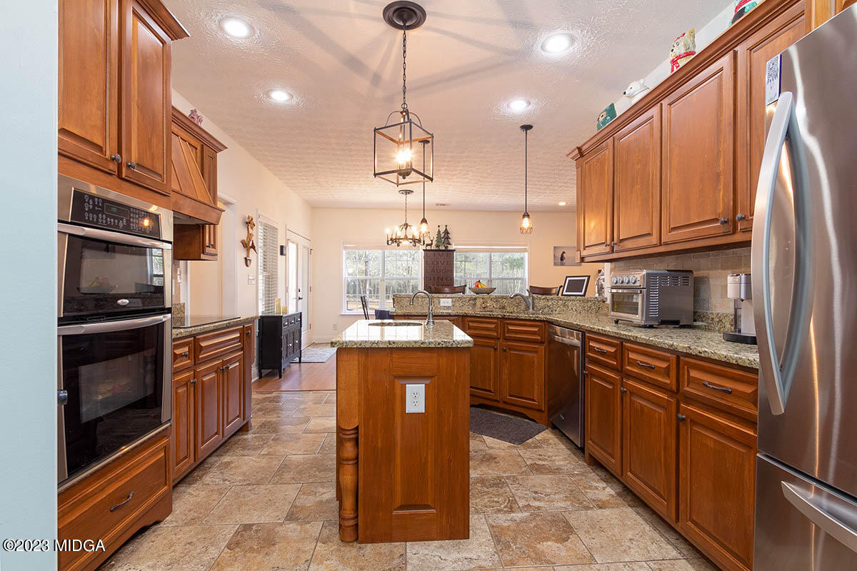 170 Terrell Road Elko, GA 31025 - Photo 11 of 35 a kitchen with stainless steel appliances granite countertop a refrigerator a stove a sink and a microwave