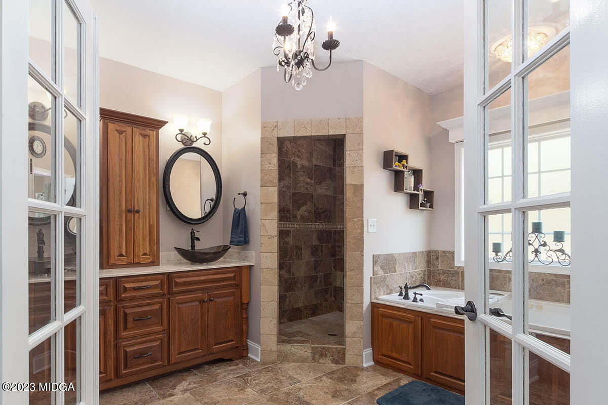 170 Terrell Road Elko, GA 31025 - Photo 14 of 35 a bathroom with double vanity sink a mirror a lamp and bathtub