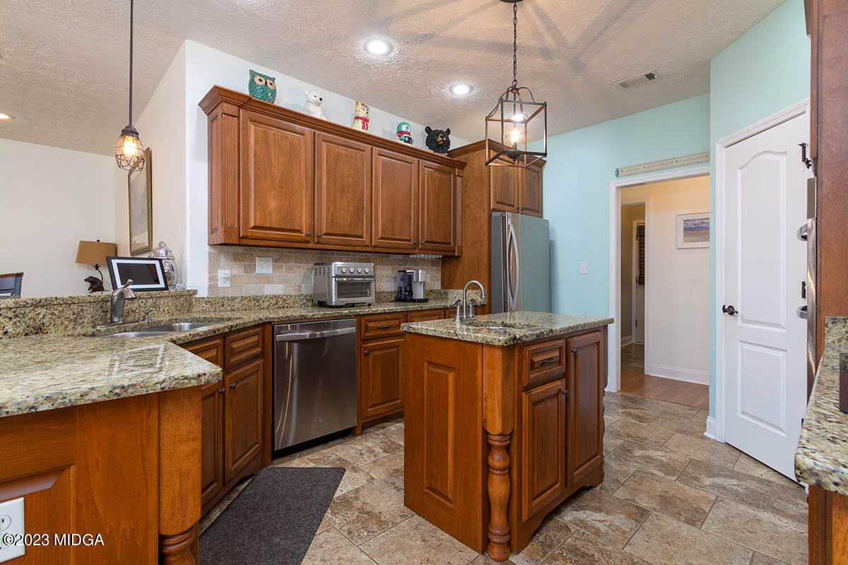 170 Terrell Road Elko, GA 31025 - Photo 10 of 35 a kitchen with stainless steel appliances granite countertop a sink stove and refrigerator