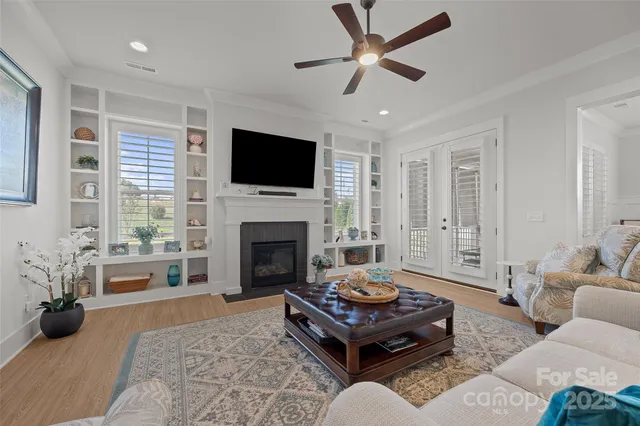 a dining room with furniture potted plants and wooden floor