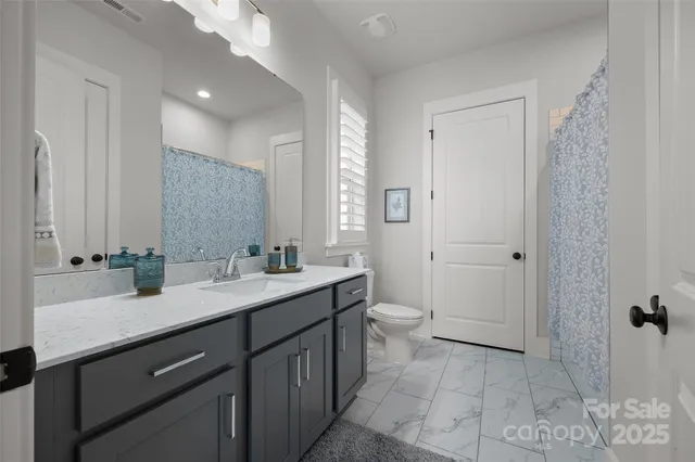 a bed room with a bed and a chair