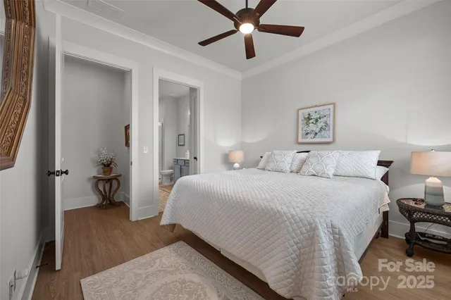 a bathroom with a granite countertop sink a toilet a shower and a mirror