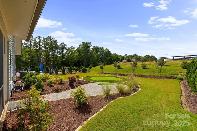 a view of a house with swimming pool and a yard