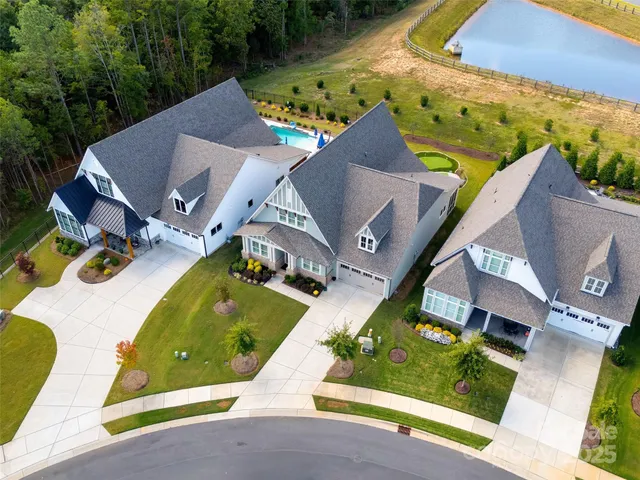 an aerial view of residential house with outdoor space and swimming pool
