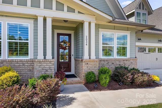 a view of a hallway view with wooden floor and a bathroom