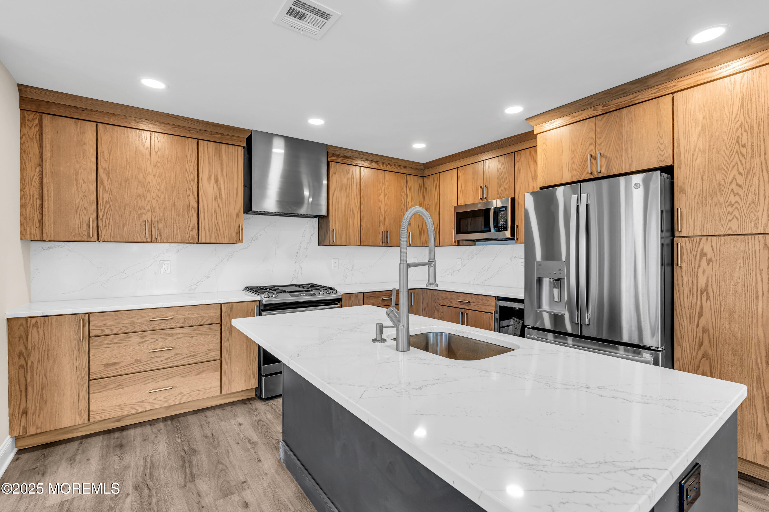 1900 Main Street Belmar, NJ 07719 - Photo 5 of 20 a kitchen with stainless steel appliances a sink a stove a refrigerator cabinets and wooden floor