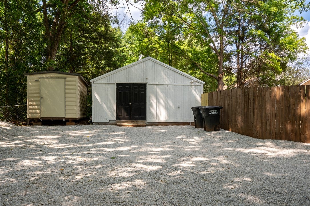 1312 Rocky Brook Road Opelika, AL 36801 - Photo 39 of 45 This private yard offers versatile utility buildings and a convenient gravel parking area.