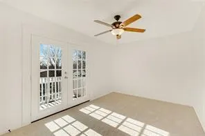 a view of a livingroom with a ceiling fan and window