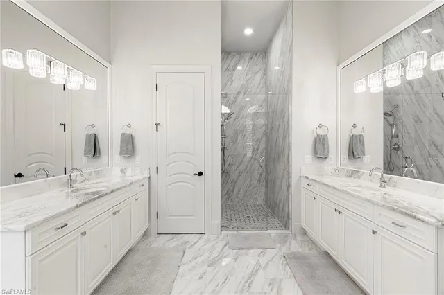 a spacious bathroom with a double vanity sink mirror and shower