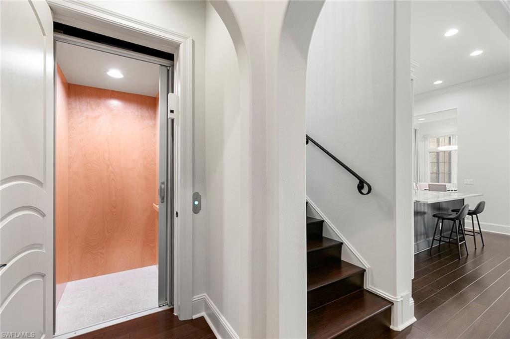 2896 Tiburon Boulevard East Naples, FL 34109 - Photo 24 of 43 a view of entryway with wooden floor and stairs