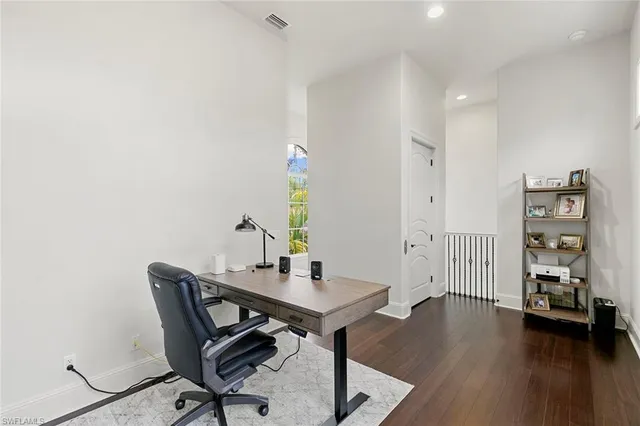 a view of a workspace with furniture and wooden floor