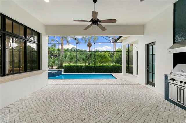 a view of a porch with a floor to ceiling window and a kitchen