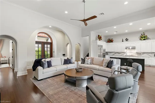 a living room with fireplace furniture and a wooden floor