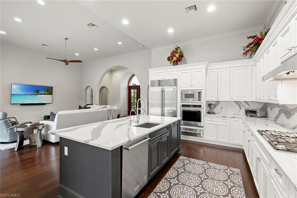 2896 Tiburon Boulevard East Naples, FL 34109 - Photo 10 of 43 a large kitchen with stainless steel appliances granite countertop a sink and cabinets