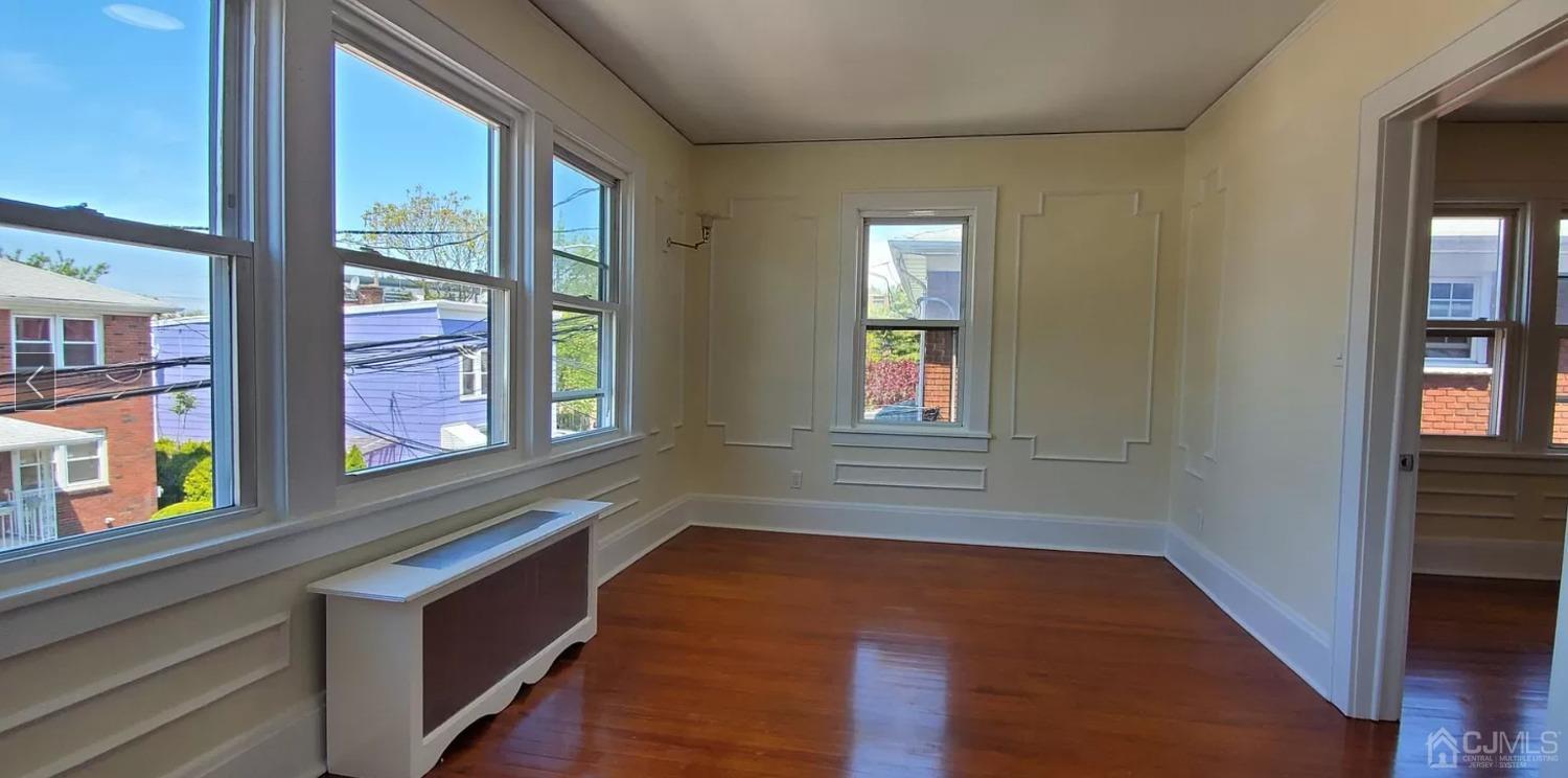 a view of an entryway with wooden floor and door
