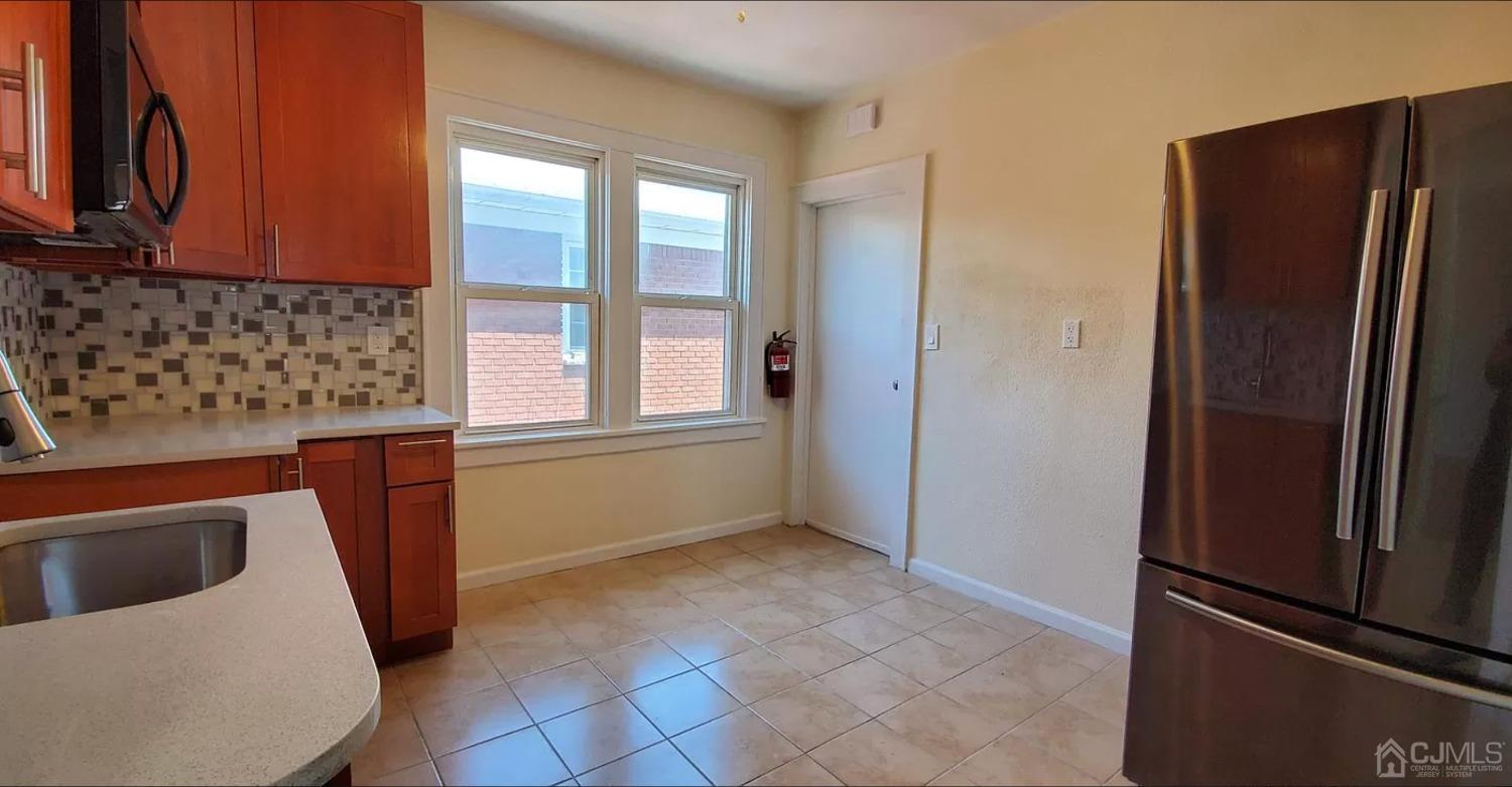 116 Race Street Elizabeth, NJ 07202 - Photo 4 of 7 a kitchen with stainless steel appliances granite countertop a refrigerator and a sink
