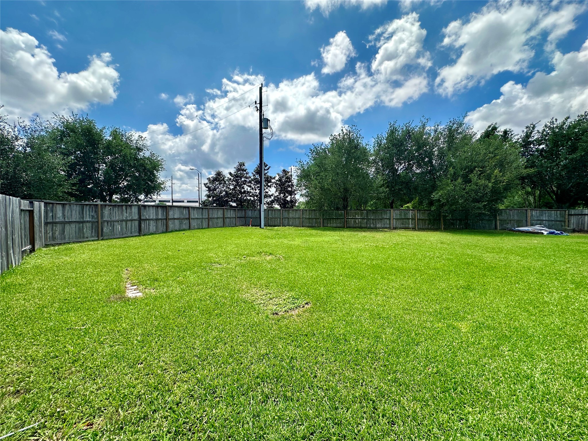 18622 Each Elm Way Houston, TX 77084 - Photo 35 of 35 a view of a big yard with a swimming pool and fire pit