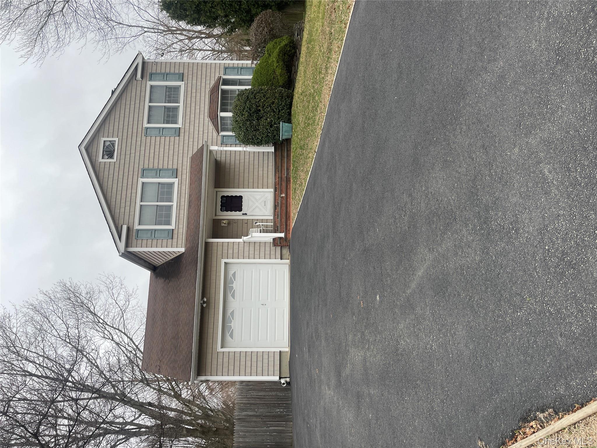 185 Birch Road Kings Park, NY 11754 - Photo 1 of 1 a front view of a house with a yard and garage