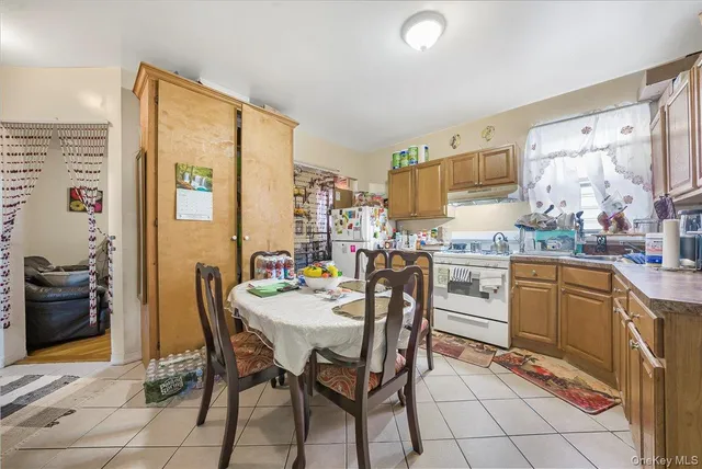 a view of a dining room with furniture and a kitchen