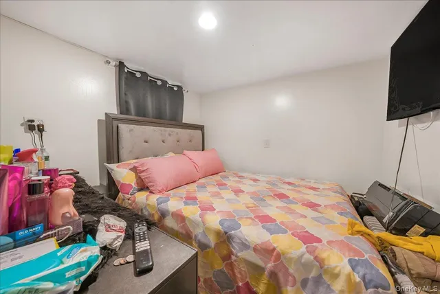 a bedroom with a bed and flat screen tv