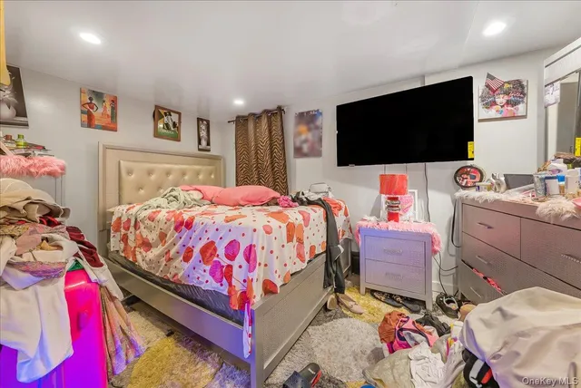 a bedroom with a bed and flat screen tv
