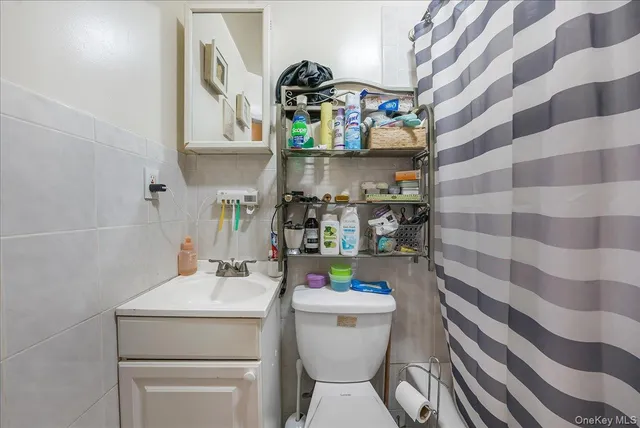 a bathroom with a sink toilet and mirror