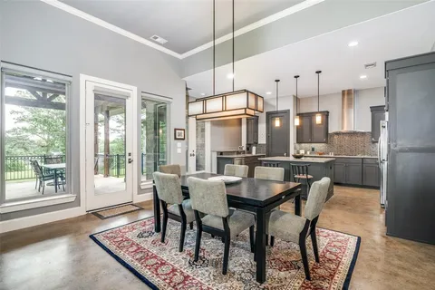 a kitchen with kitchen island granite countertop a sink a center island and stainless steel appliances