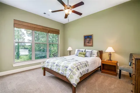 a bedroom with a bed and a large window