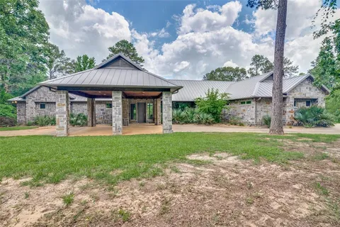 a view of a house with yard and a garden