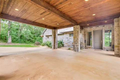 a view of a porch with floor to ceiling window and trees