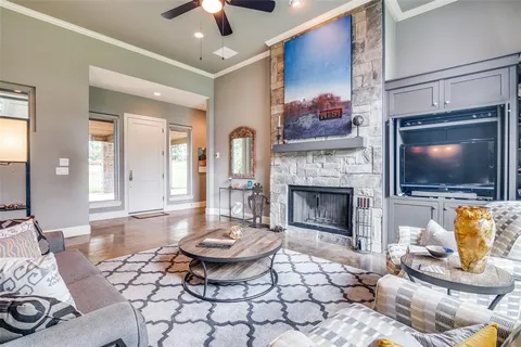 a living room with furniture a fireplace and a table