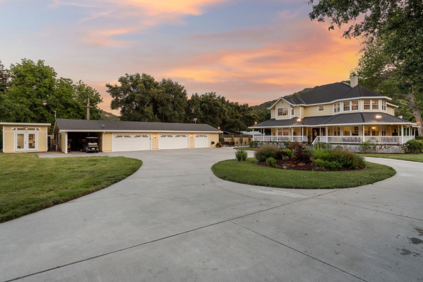 a view of a house with a yard and potted plants