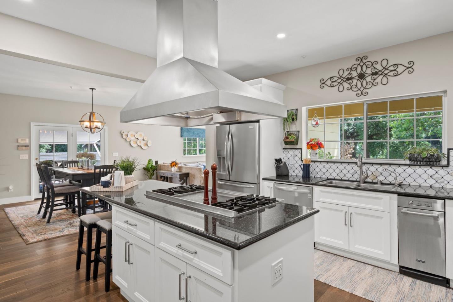 12135 Watsonville Road Gilroy, CA 95020 - Photo 11 of 83 a kitchen with stainless steel appliances granite countertop a sink a stove and a wooden floors